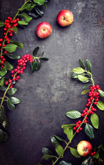 Traditional Autumn frame decoration with apples and branch with berries as top view with copy space in the middle on a rusty metal sheet