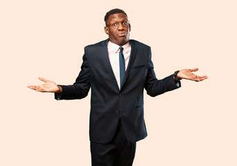 african american businessman feeling puzzled and confused, doubting, weighting or choosing...