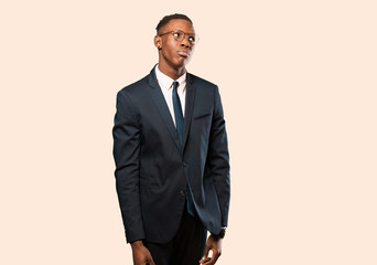 african american businessman with a worried, confused, clueless expression, looking up to copy...