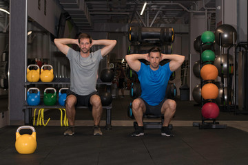 Fototapeta na wymiar Couple of guys doing some workout at the gym. Motivation moments.