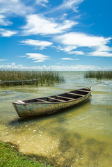 Obraz premium Landscape with old wooden boat belonging to local fishermen at Barranco beach, located in the city of São José do Norte, in southern Brazil.
