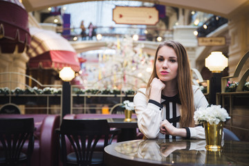 the girl in the cafe. at the table