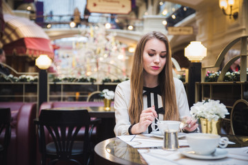 the girl in the cafe. at the table