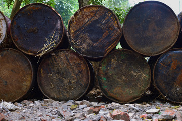 Old tin barrels from the oil. Background, abstract pattern. Colorful cans on the street. Old vintage cask. Rusted oil tins. Cans with chemicals.