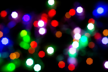 Christmas lights are lit on a black background. Copy the area for the top view text.