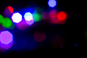 Christmas lights are lit on a black background. Copy the area for the top view text.