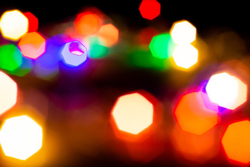 Christmas lights are lit on a black background. Copy the area for the top view text.