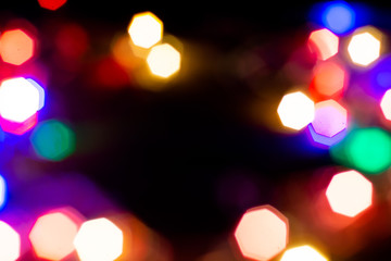 Christmas lights are lit on a black background. Copy the area for the top view text.