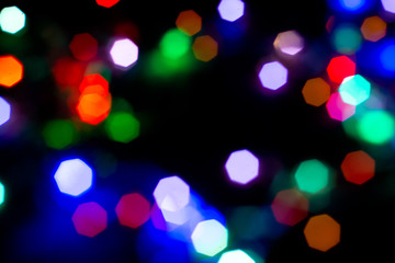 Christmas lights are lit on a black background. Copy the area for the top view text.