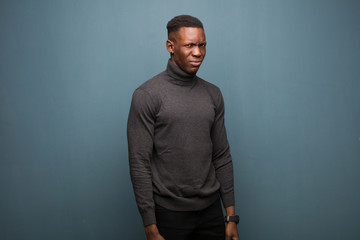 young african american black man looking happy and friendly, smiling and winking an eye at you with...