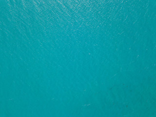 Aerial view of turquoise waves, water surface texture. Thailand