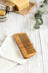 Fototapeta na wymiar Natural bathroom accessories, wooden comb, vertical
