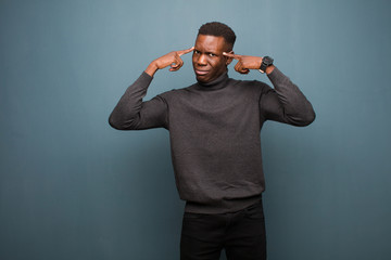 young african american black man with a serious and concentrated look, brainstorming and thinking...