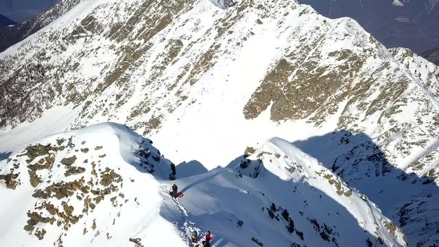 4k aerial top down drone footage flying around  the snowy mountain ridge of Tartano Valley in Sondrio province, italian mountains in the central alps.