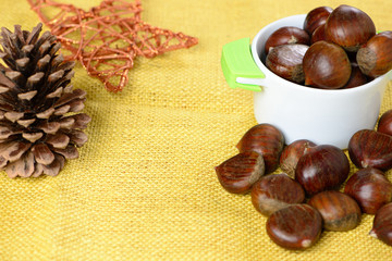 portuguese nuts in ceramic container over yellow jute and with Christmas ornaments