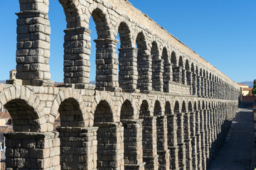 Fototapeta premium Famous Segovia aqueduct in the center of the citadel, unesco world heritage in spain. Rome architecture with medieval arch and pillars.