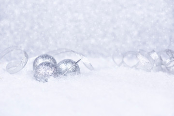 Fototapeta na wymiar Christmas background. Christmas white and silver decorations on white snow