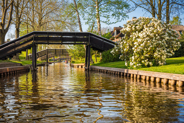 Wooden footbridges over canal with boats, Giethoorn, Netherlands