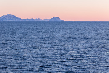 Sunset over the sea during the ferry trip to Lofoten islands (Norway) in winter