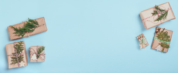 Nice presents wrapped in craft paper on blue paper background