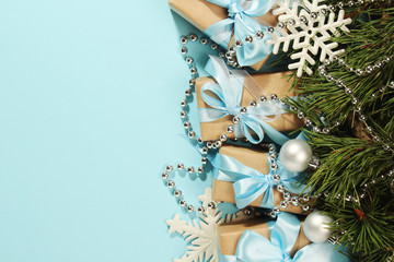 Gift boxes wrapped in craft paper with blue satin ribbons	