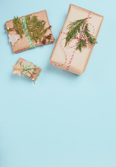 Boxes wrapped in craft paper on blue paper background