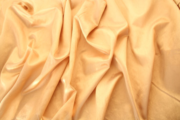Obraz premium beautiful silk fabric of delicate doggie color, light orange, draped with small folds, softly flowing, luxurious, wedding concept, texture, background, card form, copy space