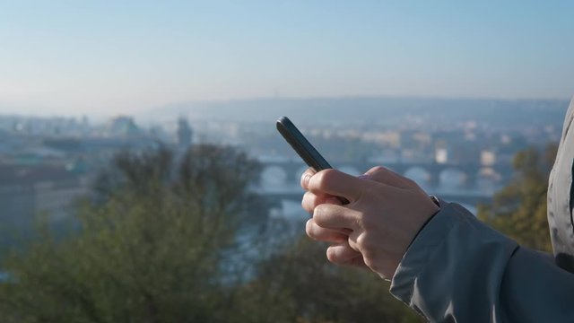 Smartphone in female hands close-up. Tourist's hands with a smartphone. Examine the map in the gadget.