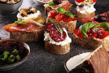 Appetizers table with italian antipasti snacks and wine in glasses. Brushetta or authentic traditional spanish tapas set, cheese variety