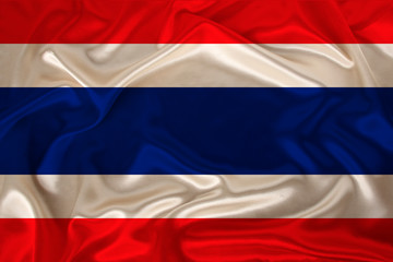 Obraz premium photo of Thailand national flag on a luxurious texture of satin, silk with waves, folds and highlights, closeup, copy space, travel concept, economy and state policy, illustration