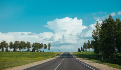 Road trip view from the car to asphalt raod and blue sky