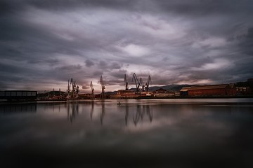 Bilbao industrial port city reflected in the lake under the storm clouds in Vizcaya, Spain