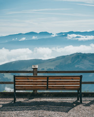 Naklejka na ściany i meble Wooden bench on top of Monte Balco in Lake Garda area