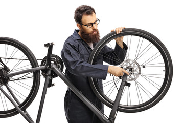 Professional man mending a bicycle isolated on white background