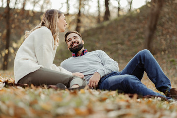 Fototapeta premium Young happy couple enjoying in autumn day and talking to each other
