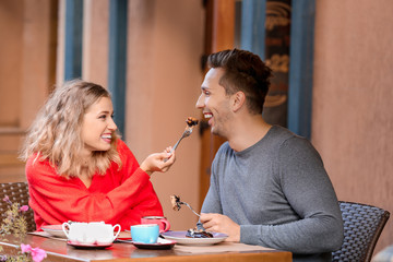 Happy young couple on romantic date in cafe