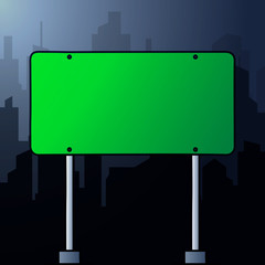 Obraz premium Rectangular green road sign on a background landscape of a night city. Copy space for text.