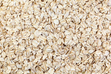 Oatmeal flakes closeup. Golden cereal muesli, background and texture. Healthy breakfast.