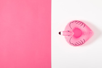 Summer beach composition. pink inflatable mini flamingo on pastel  pink background, pool float...
