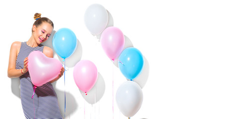 Fototapeta na wymiar Beauty girl with colorful air balloons laughing over white background. Beautiful Happy Young woman on birthday holiday party. Joyful model having fun, playing, celebrating with pastel color balloon