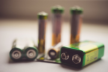 Different types of new batteries on the table close-up.