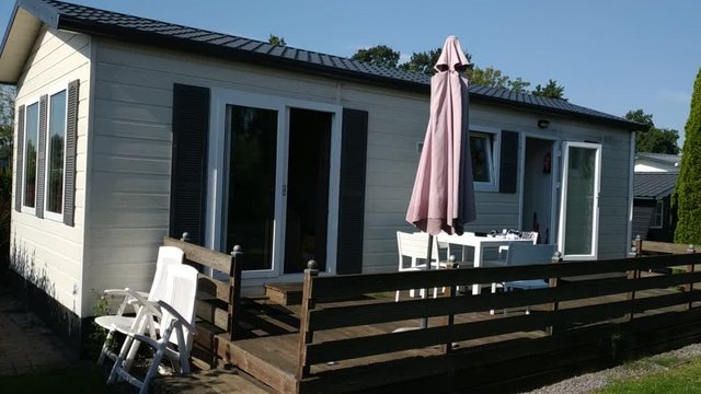 Goes, Netherlands. August 2019. In a campsite near Goes a nice bungalow with private garden. Pan 30fps movement