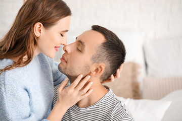 Portrait of happy young couple at home