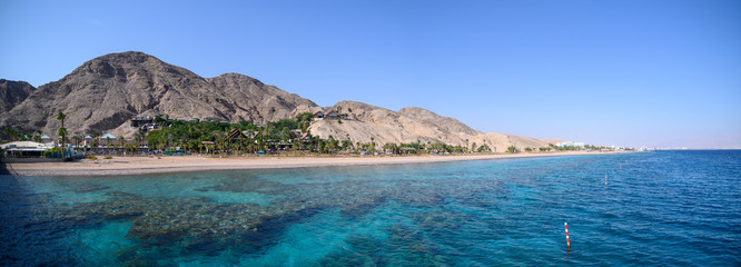 View on coral reef and resort hotels at southern beach of Eilat city aerial view shot from the sea