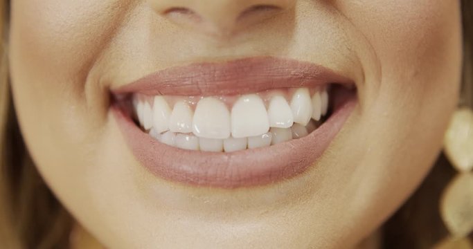 Close up of smile with white healthy teeth. Beautiful wide smile of young fresh woman with great healthy white teeth. Select 4K.