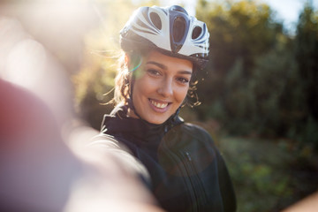 Happy active female cyclist make selfie