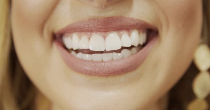 Close up of smile with white healthy teeth. Beautiful wide smile of young fresh woman with great healthy white teeth. Select 4K.