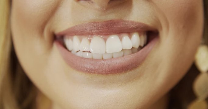 Close up of smile with white healthy teeth. Beautiful wide smile of young fresh woman with great healthy white teeth. Select 4K.