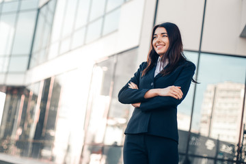 Successful smile businesswoman or entrepreneur standing in front of his office.