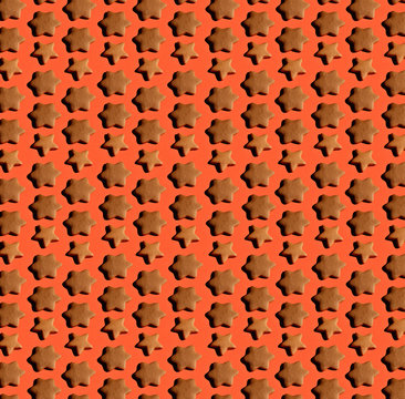 Collection of gingerbread stars on a wooden board with hard shadows on living coral background